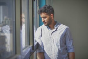 Man in window symbolising behaviours that undermind business owners